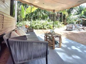 a living room with a couch and a table at Vintage Coral Pink in Nelly Bay