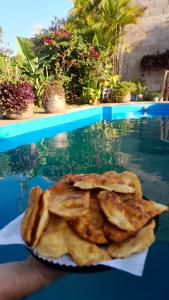 a plate of food sitting next to a swimming pool at Óga Rory in Corrientes