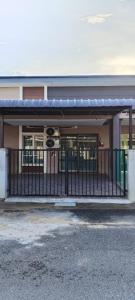 a building with a fence in front of it at Sobey Laris Homestay PASIR MAS in Pasir Mas