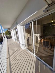 an empty balcony of a house with glass windows at Consorcio 9 de Julio in San Juan +7 photos
