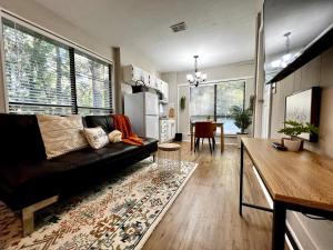a living room with a black couch and a table at Guest Studio in Gainesville