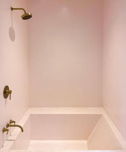 a bathroom with a bath tub in a room at Casa Rocha in Rio de Janeiro
