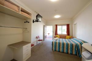 A bed or beds in a room at Lamington Hotel Motel - Detached Motel