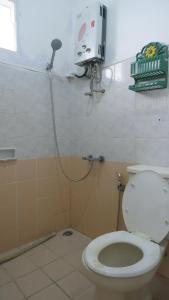 a bathroom with a toilet and a shower at Villa Dalia Puncak H1-26 in Cikundul +17 photos