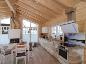 a kitchen with a stove and a table in a room at Holiday apartment with 2 bedrooms in Clausthal-Zellerfeld