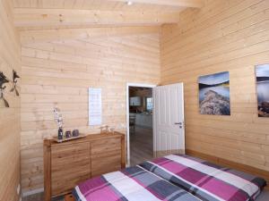 a bedroom with a bed and a wooden wall at Holiday apartment with 2 bedrooms in Clausthal-Zellerfeld