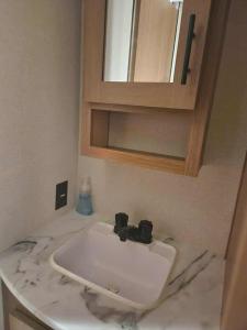 a bathroom counter with a sink and a mirror at Monday creek camper in New Straitsville +10 photos
