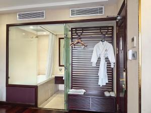 a bathroom with a glass walk in shower next to a sink at Golden Silk Boutique Hotel in Hanoi +97 photos