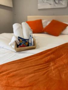 a tray of complimentary towels and towels on a bed at Lovely Double Bedroom in Liverpool