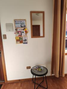 a table in a room with a mirror on a wall at Cabañas Mongetum in Constitución +7 photos