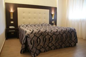 Postel nebo postele na pokoji v ubytování Hotel Michela