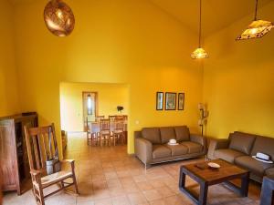a living room with two couches and a table at Spacious Holiday Home in La Oliva in Villaverde