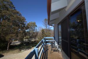 a balcony of a house with a table and chairs at Alpha Centauri - 8 - 39 Gippsland Street in Jindabyne