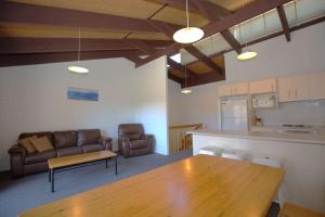 a living room with a table and a couch at Alpha Centauri - 8 - 39 Gippsland Street in Jindabyne