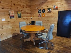 a conference room with a wooden table and chairs at TheGapCabin in Buffalo Gap +6 photos