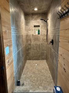a bathroom with a shower with a tiled shower at TheGapCabin in Buffalo Gap
