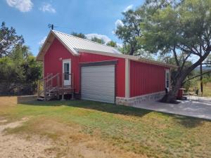 a red building with a garage at TheGapCabin in Buffalo Gap
