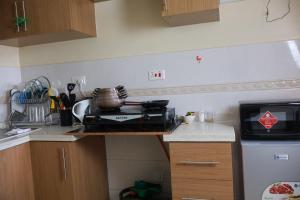 a kitchen with a counter top with a stove at Maya City View Studios in Nairobi