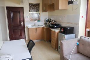 a small kitchen with a sink and a stove at Maya City View Studios in Nairobi