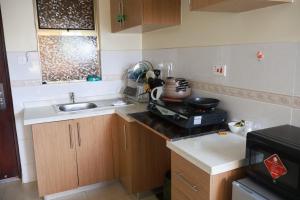 a small kitchen with a sink and a counter at Maya City View Studios in Nairobi