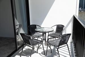 a group of chairs and a table on a balcony at Buddha View Hostel & Diving in Ko Tao