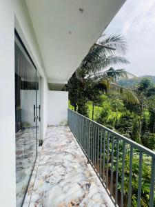 GREEN LEAF PREMIUM VILLA munnar في مونار: شرفة مطلة على نخلة