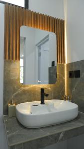 a bathroom sink with a large mirror above it at Villa Dalia Puncak NA6-06 in Cimacan +43 photos