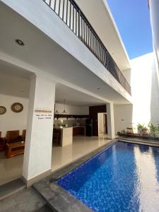 a swimming pool in the middle of a house at NEW 4 BR Korin Villa Sanur in Sanur