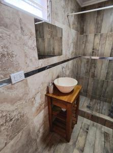 a bathroom with a sink and a mirror at Depto Civora 3 in Villa Regina