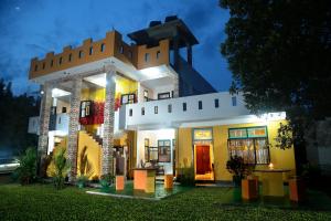 a house with a lit up facade at night at Villa Ceylon in Katunayake