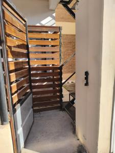 a hallway with a wooden fence and stairs at Depto Civora 3 in Villa Regina