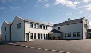 a large white building with a lot of windows at Borve House Hotel in Borve