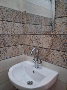 a bathroom with a sink and a mirror at Himalayan Wellness Retreat in Narendranagar