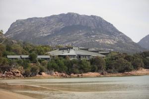 a house on a hill next to a mountain at Freycinet Lodge in Coles Bay