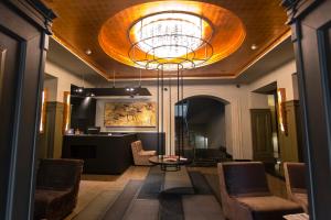 a lobby with a large ceiling with a chandelier at Amur Hotel in Khabarovsk