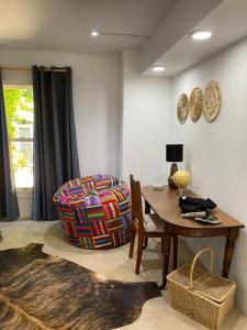 a dining room with a table and a chair at Five Kingsway in Knysna