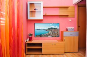 a tv sitting on a wooden stand in a room at Apartment Lorena in Split