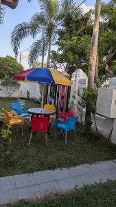 a group of chairs and a table with an umbrella at Villa 19 Zone 2 Millennium City - Jaela in Ja-Ela