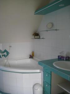 a bathroom with a white tub and a sink at Country and Town in Unterhaching