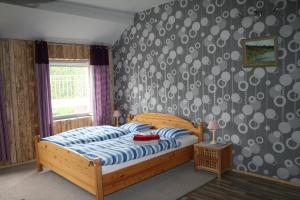 a bedroom with a bed with a blue and white comforter at Gamla Skolan Bed And Breakfast in Gubbhögen