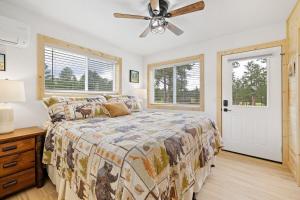 a bedroom with a bed and a ceiling fan at Custer Love Shack in Custer