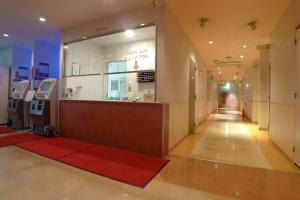 a store front with a red carpet in a hallway at Hotel Times Inn 24 in Yokohama