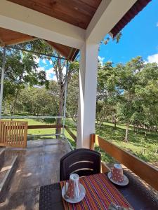 a table and chairs on a porch with a view at BellaVista 2 habitaciones con balcón in Oxapampa