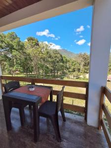 a table and chairs on a porch with a view at BellaVista 2 habitaciones con balcón in Oxapampa +6 photos