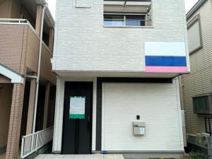 a white building with a door with a rainbow at N's room & park ,Tokyo, Guest House - Vacation STAY 18814 in Tokyo