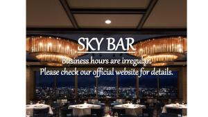 a restaurant with a sign that reads sky bar and chandeliers at Kokusai 21 International Hotel in Nagano