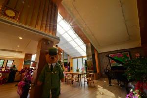 a large teddy bear standing in a room at Bear Forest Villa in Fengping