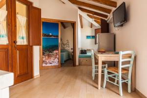 a small kitchen with a table and chairs and a room at Residenza Petrera in Muravera