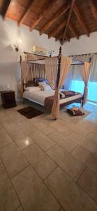 a bedroom with a canopy bed in a room at Lasa Valley Villa in Lasa +53 photos