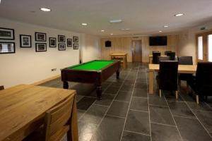 a room with a pool table and some chairs at Borve House Hotel in Borve